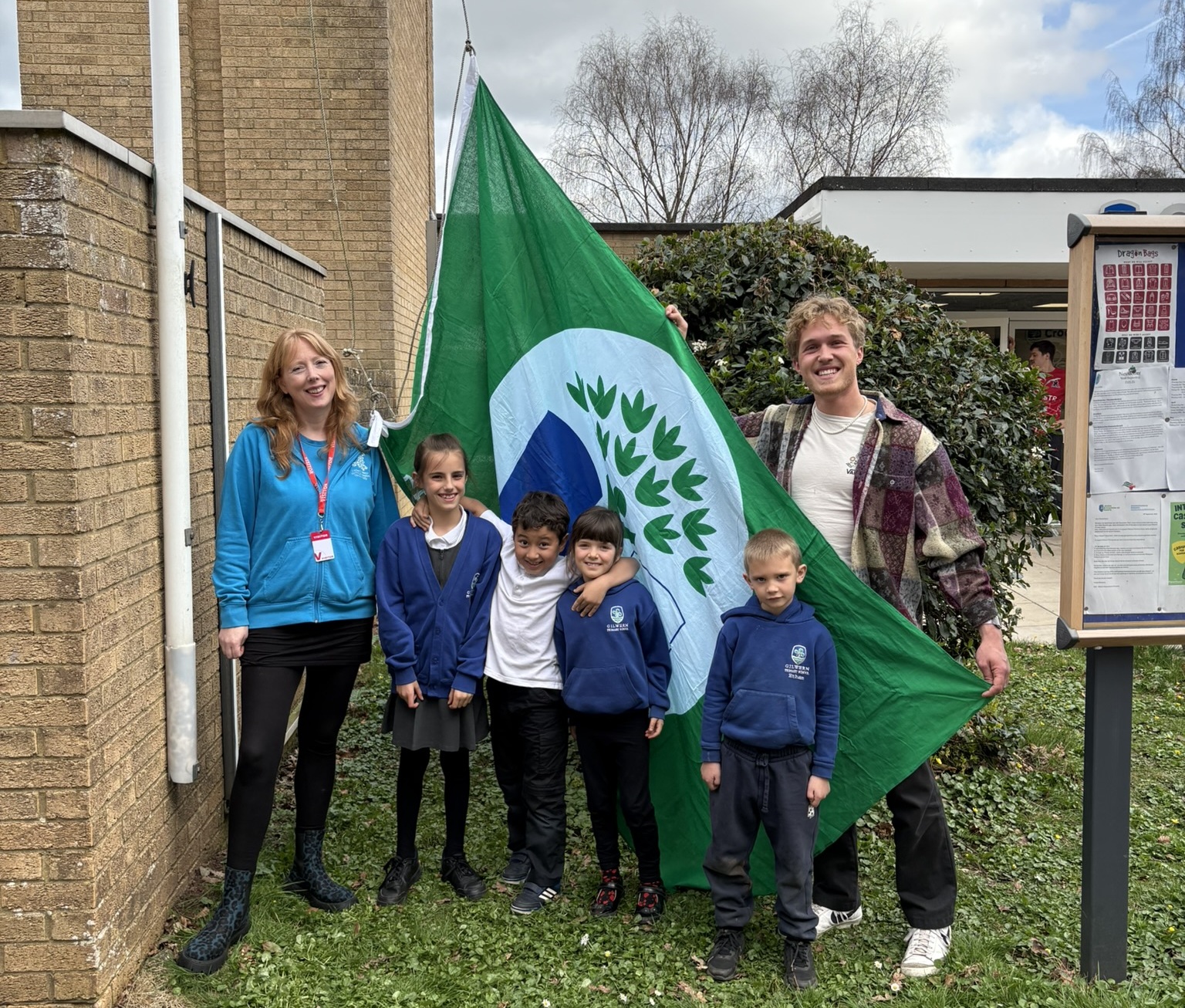 A group photo with a green flag